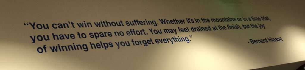 An inspirational quote by Bernard Hinault on the wall of the USA Cycling headquarters which reads: "You can't win without suffering. Whether it's in the mountains or in a time trial, you have to spare no effort. You may feel drained at the finish, but the joy of winning helps you forget everything"