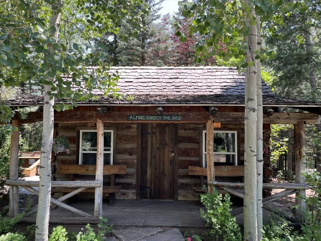 Image of a log cabin nestled in the aspen trees in Vail, CO