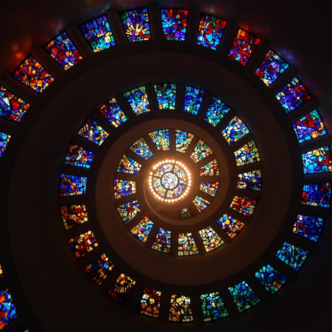 Photo by Pixabay: https://www.pexels.com/photo/worms-eye-view-of-spiral-stained-glass-decors-through-the-roof-161154/